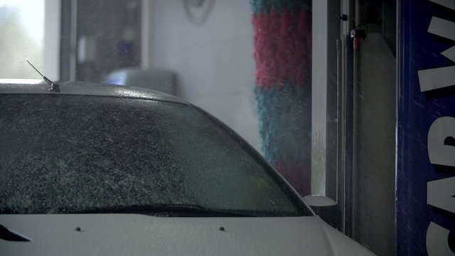 Carwash apparature spurting water mixed with cleaning liquid