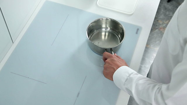 Man preparing meal for family in a modern white kichen