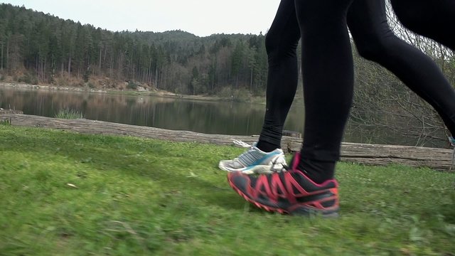 Side Shot Of Two Runners At Lake In Slow Motion
