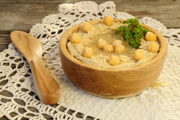 Hummus in a wooden bowl