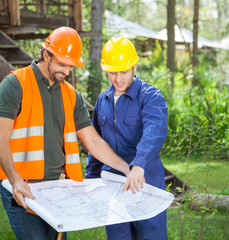 Architects Discussing Over Blueprint