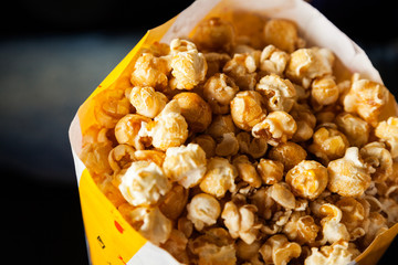 Roasted Popcorns In Paperbag At Cinema Theater