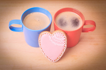 two coffee cups and heart cookies