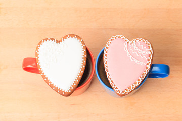 two coffee cups and heart cookies