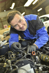 Fototapeta na wymiar Technician working in auto repair shop