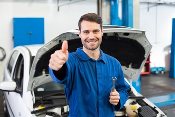 Smiling mechanic looking at camera