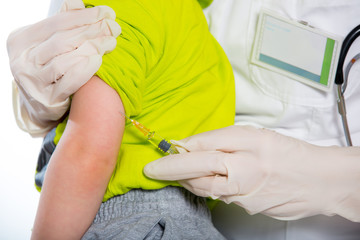 The doctor makes a baby vaccination on a white background.