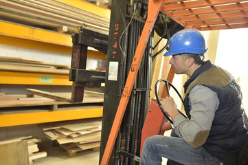 Operator in warehouse driving trolley