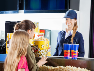 Girls Buying Snacks From Female Seller At Concession Stand © Tyler Olson