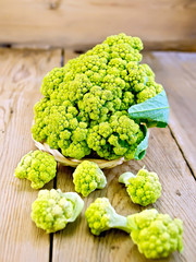 Broccoli green in wicker basket on board