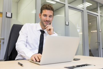 Businessman working on computer in modern office