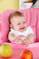Cute baby eating in the high chair