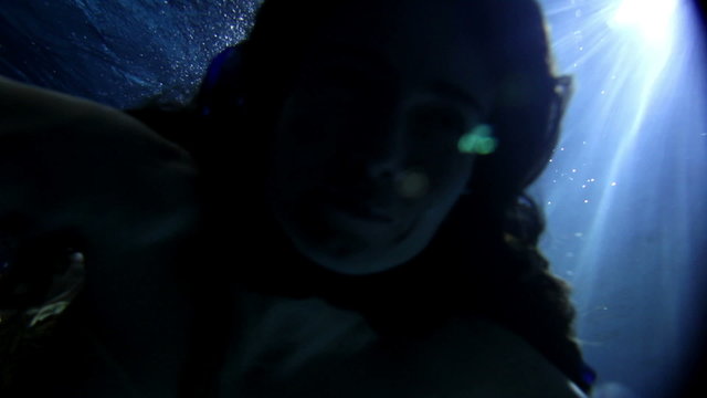 underwater activity and woman swimming under water in clothes