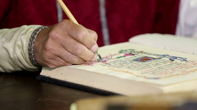 Man dressed in 19th century clothes writing into a book
