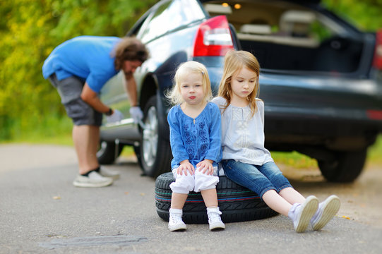 Happy Family Changing A Car Wheel