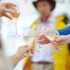 People holding wine glasses at festive event