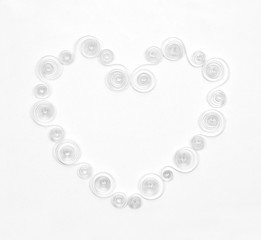 Handmade hearts cut from white paper on white background. Quilli