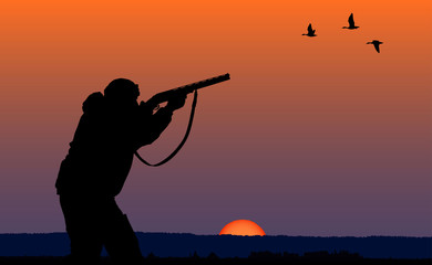 Fototapeta na wymiar hunter at sunset background