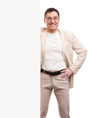 Fototapeta premium Cheerful young handsome man with blank signboard