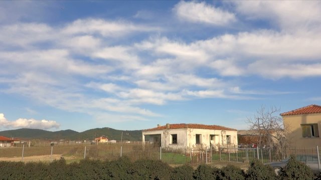 Clouds passing by over abandoned house in village in Greece