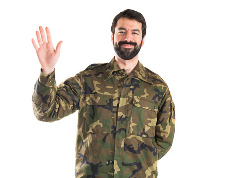 Soldier saluting over white background