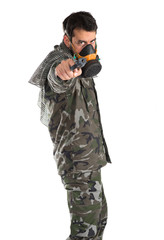 Fototapeta premium Soldier with gas mask shooting a gun