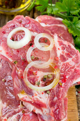 raw rump steaks on wooden table