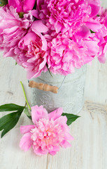 bunch of pink peonies in a can