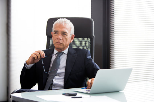thoughtful businessman in the office with laptop