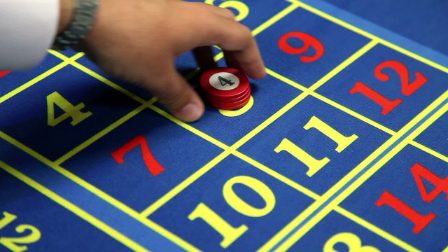 Detail of betting at number eight at roulette table in casino