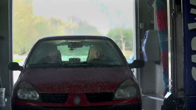 Front shot of car being sprayed with shampoo