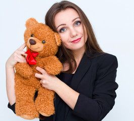 Young smiling beautiful woman holding teddy bear.