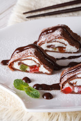 Japanese chocolate crepe roll with cheese close-up. Vertical