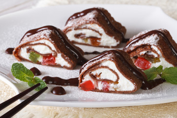 Japanese chocolate crepe rolls with cheese close-up. Horizontal