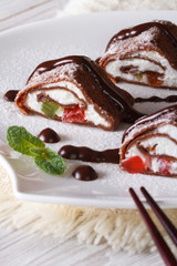 Japanese chocolate crepe rolls with cheese close-up. Vertical