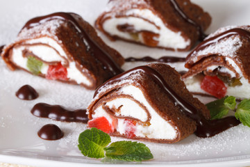 chocolate crepe rolls with cheese, fruit and mint closeup.