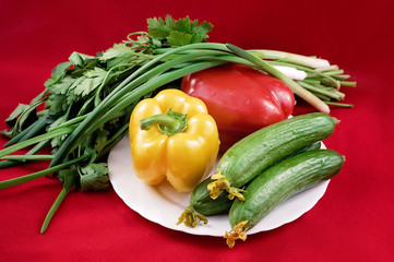 Fresh market vegetables on red background
