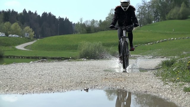 Mountain bike driving over the water 