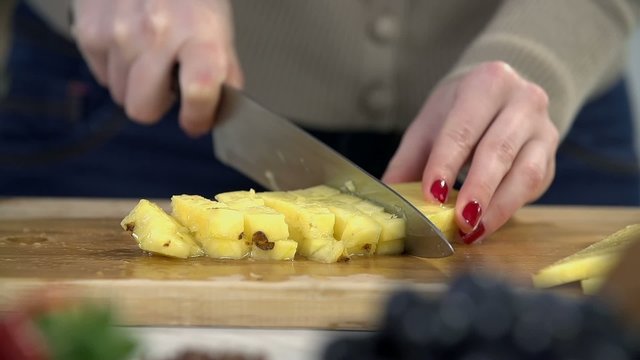 Slicing pineapple on the cutting board