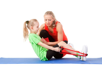 Little girl doing exercise with an instructor
