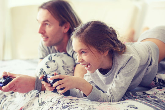 Child playing video game with father