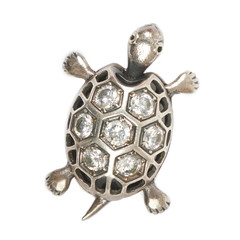 Silver turtle pendant with diamonds on a white background