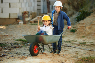 boy and girl playing on construction site