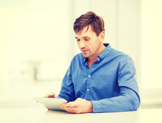 man working with tablet pc at home