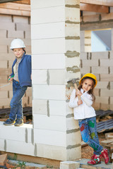 boy and girl playing on construction site