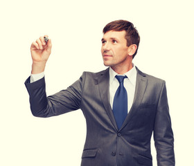 attractive buisnessman or teacher with marker