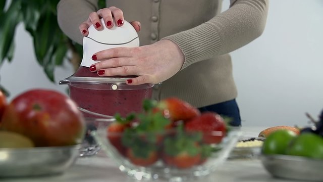 Blending red fruit in mixer
