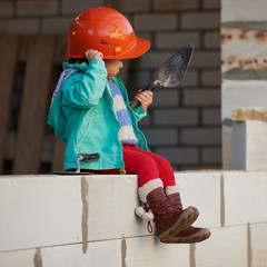girl with helmet working on construction