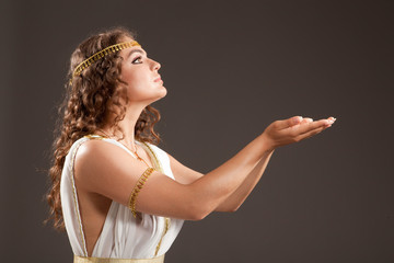 Classical Greek Goddess in Tunic Carrying Something on her Hands © AlexanderNovikov