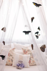 Beautiful tropical butterflies on white canopy. Sleep mood.